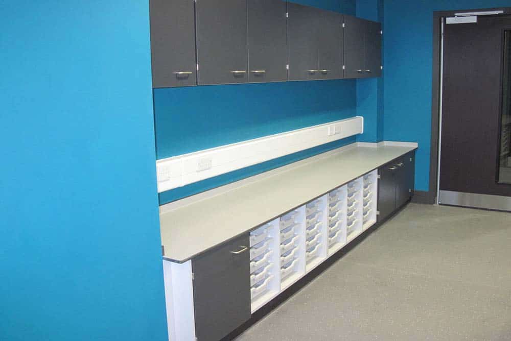 Southfield School classroom storage with blue contrast wall.