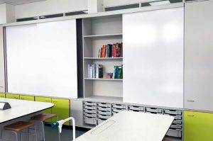 Teacher Wall design with shelving and sliding whiteboards